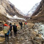 group-of-people-trekking-on-a-valley-towards-the-P4U4PG5